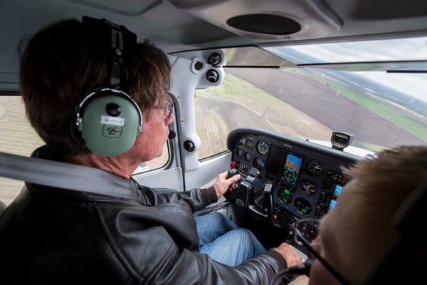 A pilot flying the airplane while his DPE looks on from the right seat